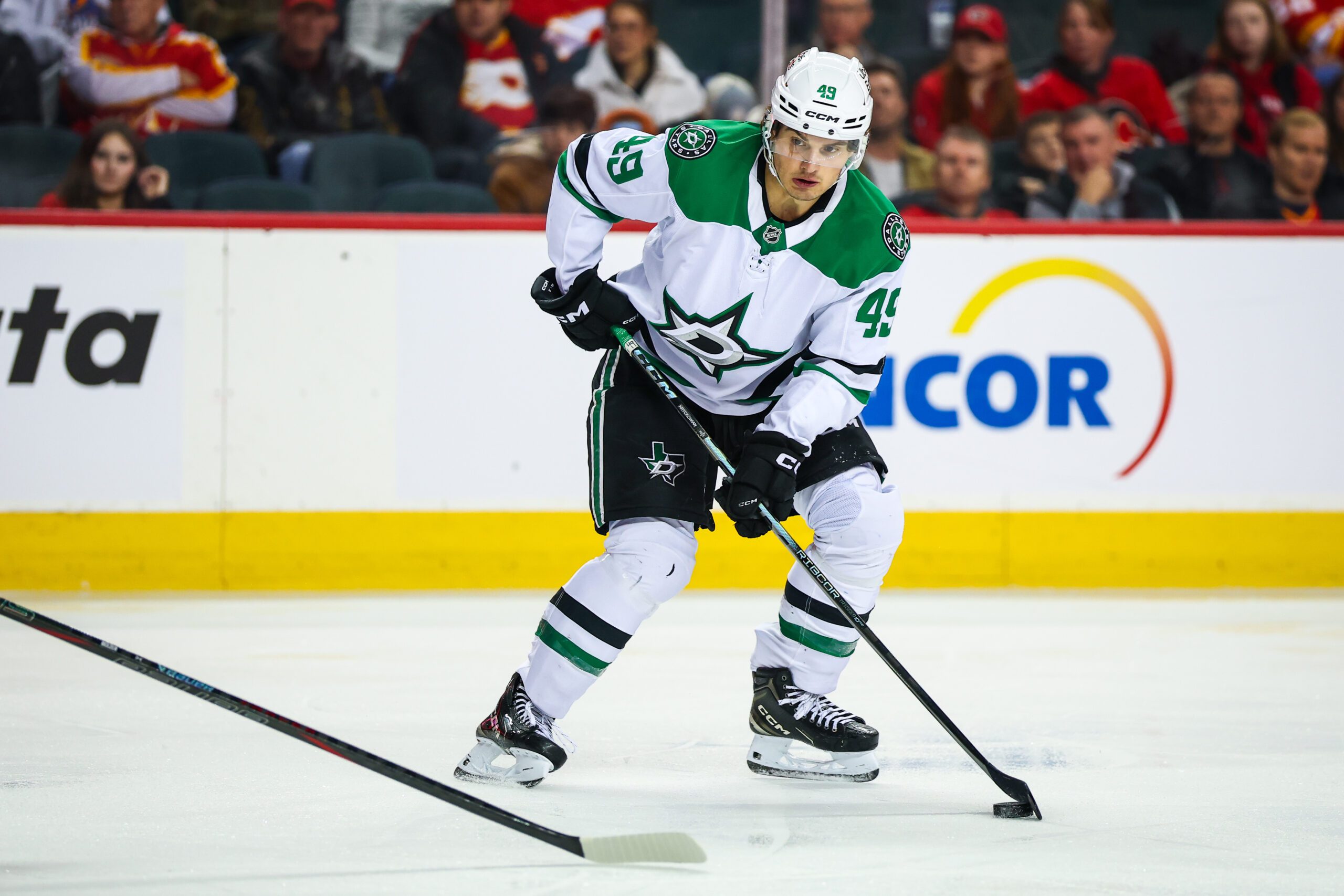 Mar 3, 2026; Calgary, Alberta, CAN; Dallas Stars center Justin Hryckowian (49) controls the puck against the Calgary Flames during the third period at Scotiabank Saddledome. Mandatory Credit: Sergei Belski-Imagn Images