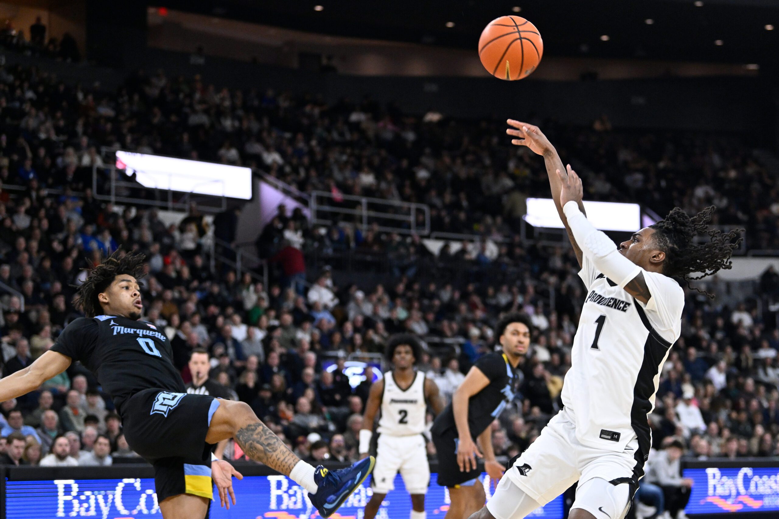 Mar 4, 2026; Providence, Rhode Island, USA; Providence Friars guard Jason Edwards (1) shoots the ball over Marquette Golden Eagles guard Nigel James Jr. (0) during the first half at Amica Mutual Pavilion. Mandatory Credit: Eric Canha-Imagn Images