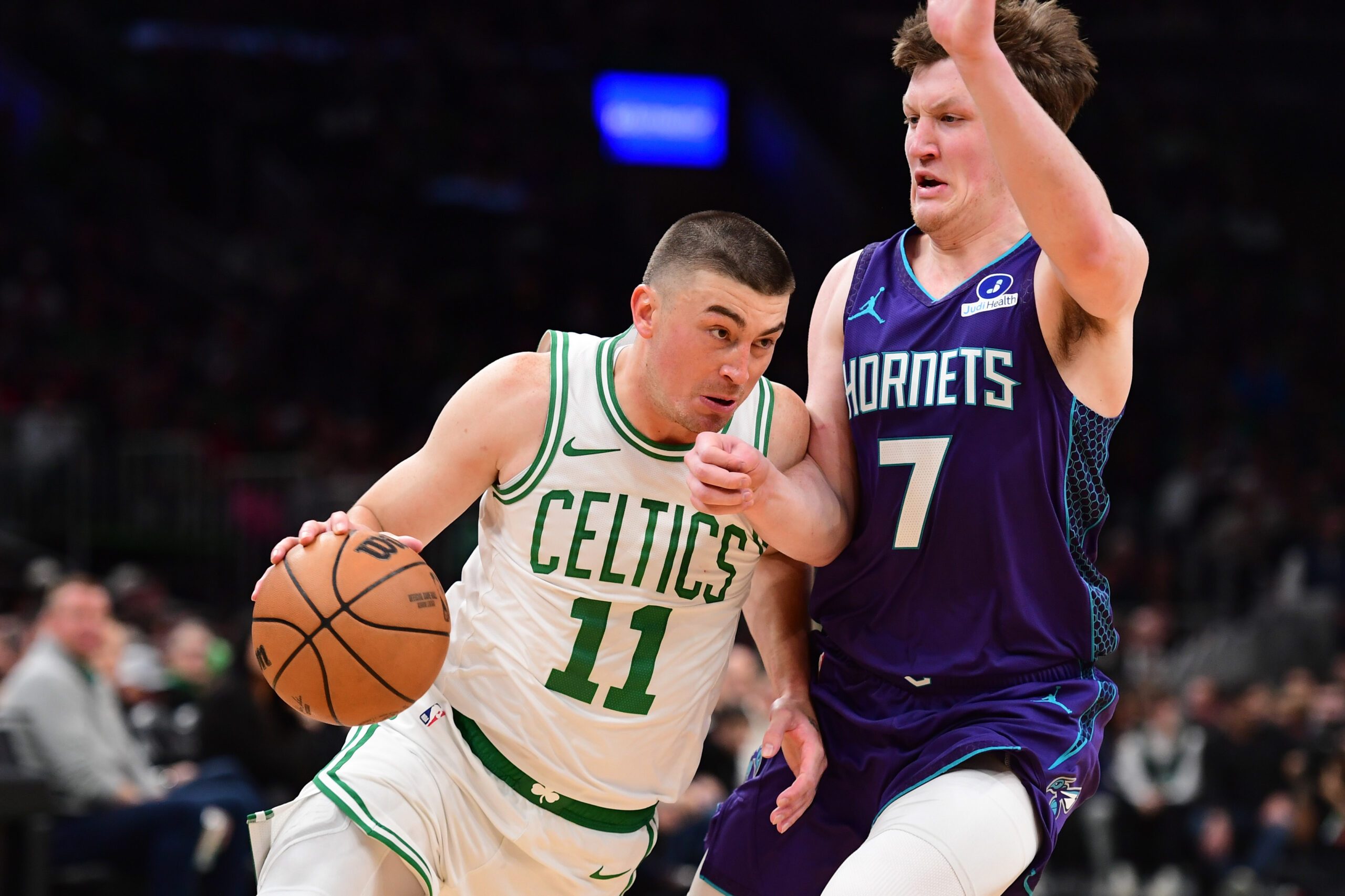 Mar 4, 2026; Boston, Massachusetts, USA;  Boston Celtics guard Payton Pritchard (11) drives to the basket while Charlotte Hornets guard Kon Knueppel (7) defends during the first half at TD Garden. Mandatory Credit: Bob DeChiara-Imagn Images