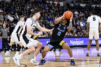 Mar 4, 2026; Providence, Rhode Island, USA; Marquette Golden Eagles guard Nigel James Jr. (0) looks to shoot against Providence Friars guard Ryan Mela (11) during the second half at Amica Mutual Pavilion. Mandatory Credit: Eric Canha-Imagn Images