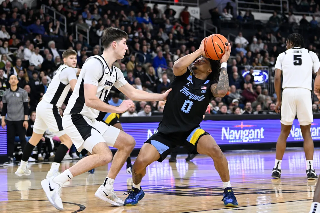 Mar 4, 2026; Providence, Rhode Island, USA; Marquette Golden Eagles guard Nigel James Jr. (0) looks to shoot against Providence Friars guard Ryan Mela (11) during the second half at Amica Mutual Pavilion. Mandatory Credit: Eric Canha-Imagn Images