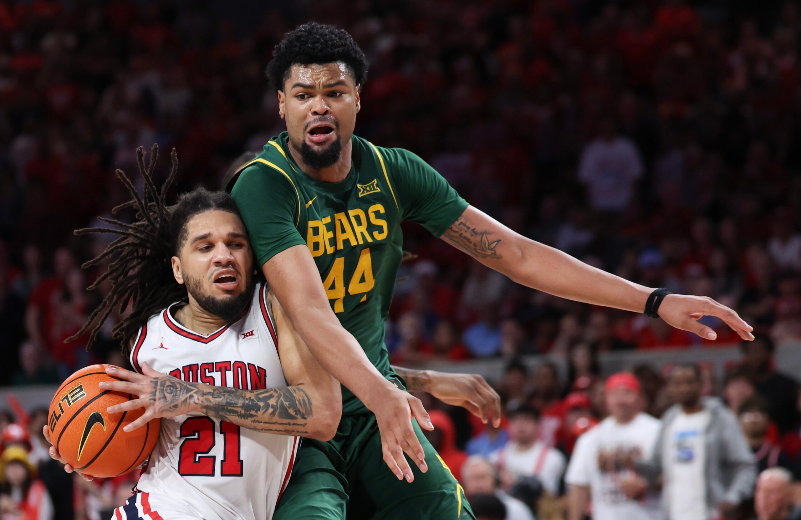 Mar 4, 2026; Houston, Texas, USA; Houston Cougars guard Emanuel Sharp (21) drives to the basket against Baylor Bears center Caden Powell (44) in the second half at Fertitta Center. Mandatory Credit: Thomas Shea-Imagn Images