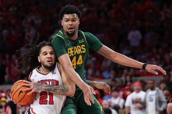 Mar 4, 2026; Houston, Texas, USA; Houston Cougars guard Emanuel Sharp (21) drives to the basket against Baylor Bears center Caden Powell (44) in the second half at Fertitta Center. Mandatory Credit: Thomas Shea-Imagn Images