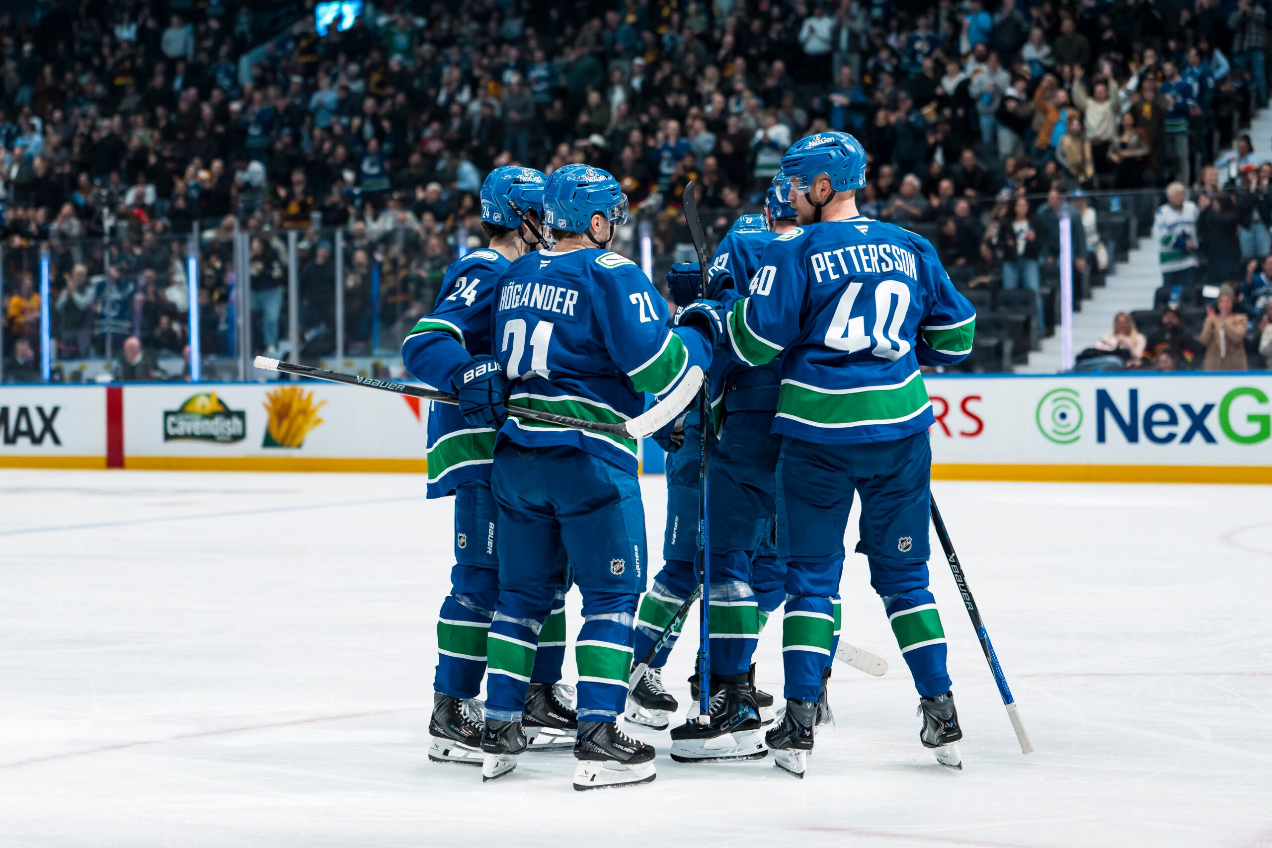 Mar 4, 2026; Vancouver, British Columbia, CAN; Vancouver Canucks defenseman Zeev Buium (24) and forward Nils Hoglander (21) and defenseman Filip Hronek (17) and forward Elias Pettersson (40) celebrate Hoglander’s goal against the Carolina Hurricanes in the third period at Rogers Arena. Mandatory Credit: Bob Frid-Imagn Images