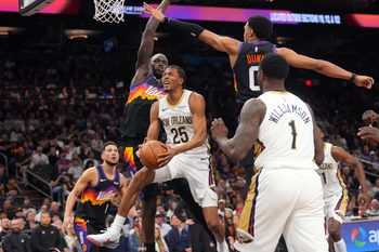 Mar 6, 2026; Phoenix, Arizona, USA; New Orleans Pelicans forward Trey Murphy III (25) drives against Phoenix Suns forward Ryan Dunn (0) and Phoenix Suns center Khaman Maluach (10) during the second half at Mortgage Matchup Center. Mandatory Credit: Joe Camporeale-Imagn Images