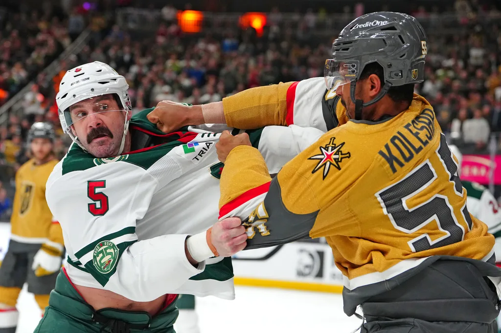 Mar 6, 2026; Las Vegas, Nevada, USA; Minnesota Wild defenseman Jake Middleton (5) fights Vegas Golden Knights right wing Keegan Kolesar (55) during the second period at T-Mobile Arena. Mandatory Credit: Stephen R. Sylvanie-Imagn Images