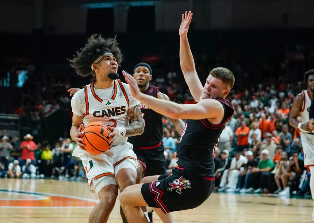 Mar 7, 2026; Coral Gables, Florida, USA; Miami Hurricanes guard Tre Donaldson (3) drives to the basket against Louisville Cardinals guard Isaac McKneely (10) during the second half at Watsco Center. Mandatory Credit: Jeff Romance-Imagn Images