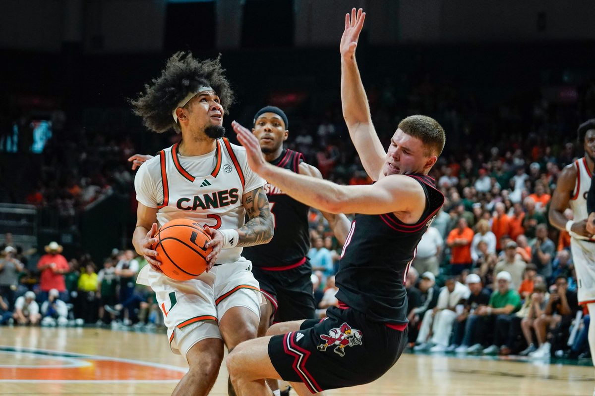 Mar 7, 2026; Coral Gables, Florida, USA; Miami Hurricanes guard Tre Donaldson (3) drives to the basket against Louisville Cardinals guard Isaac McKneely (10) during the second half at Watsco Center. Mandatory Credit: Jeff Romance-Imagn Images