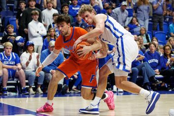Mar 7, 2026; Lexington, Kentucky, USA; Kentucky Wildcats guard Collin Chandler (5) attempts to steal the ball from Florida Gators guard Urban Klavzar (7) during the second half at Rupp Arena at Central Bank Center. Mandatory Credit: Jordan Prather-Imagn Images