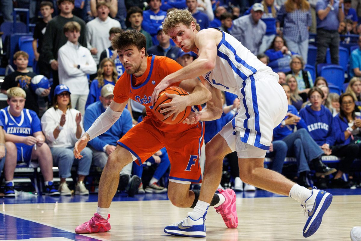 Mar 7, 2026; Lexington, Kentucky, USA; Kentucky Wildcats guard Collin Chandler (5) attempts to steal the ball from Florida Gators guard Urban Klavzar (7) during the second half at Rupp Arena at Central Bank Center. Mandatory Credit: Jordan Prather-Imagn Images