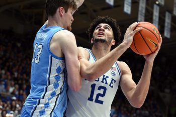 Mar 7, 2026; Durham, North Carolina, USA; Duke Blue Devils forward Cameron Boozer (12) looks to shoot as North Carolina Tar Heels center Henri Veesaar (13) defends during the second half at Cameron Indoor Stadium.  The Duke Blue Devils won 76-61. Mandatory Credit: Rob Kinnan-Imagn Images
