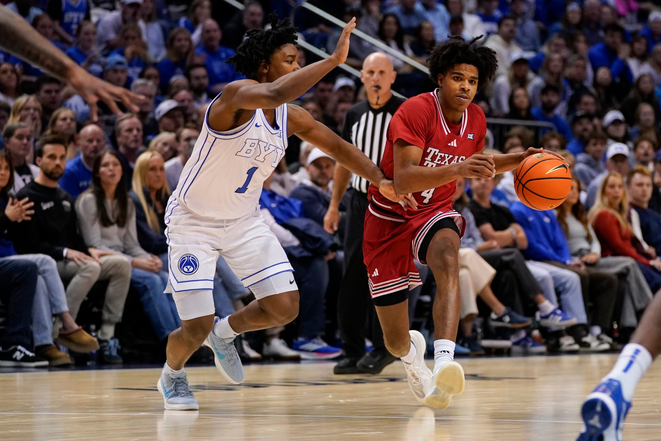 Mar 7, 2026; Provo, Utah, USA; Texas Tech Red Raiders guard Christian Anderson (4) controls the ball while being defended by BYU Cougars guard Robert Wright III (1) during the second half at Marriott Center. Mandatory Credit: Aaron Baker-Imagn Images