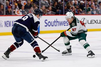 Mar 8, 2026; Denver, Colorado, USA; Minnesota Wild left wing Kirill Kaprizov (97) controls the puck as Colorado Avalanche defenseman Cale Makar (8) defends in the third period at Ball Arena. Mandatory Credit: Isaiah J. Downing-Imagn Images