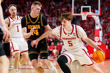 Mar 8, 2026; Lincoln, Nebraska, USA; Nebraska Cornhuskers forward Braden Frager (5) drives against Iowa Hawkeyes guard Bennett Stirtz (14) during the first half at Pinnacle Bank Arena. Mandatory Credit: Dylan Widger-Imagn Images