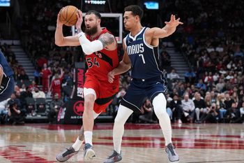 Mar 8, 2026; Toronto, Ontario, CAN; Toronto Raptors forward Sandro Mamukelashvili (54) controls the ball as Dallas Mavericks forward Dwight Powell (7) tries to defend during the fourth quarter at Scotiabank Arena. Mandatory Credit: Nick Turchiaro-Imagn Images