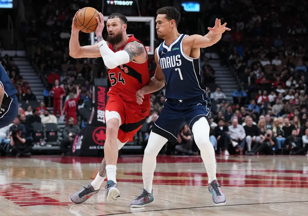 Mar 8, 2026; Toronto, Ontario, CAN; Toronto Raptors forward Sandro Mamukelashvili (54) controls the ball as Dallas Mavericks forward Dwight Powell (7) tries to defend during the fourth quarter at Scotiabank Arena. Mandatory Credit: Nick Turchiaro-Imagn Images