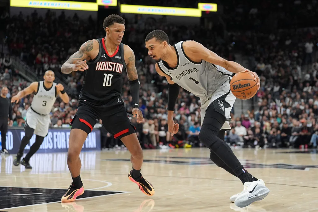 Mar 8, 2026; San Antonio, Texas, USA; San Antonio Spurs forward Victor Wembanyama (1) dribbles against Houston Rockets forward Jabari Smith Jr. (10) in the second half at Frost Bank Center. Mandatory Credit: Daniel Dunn-Imagn Images