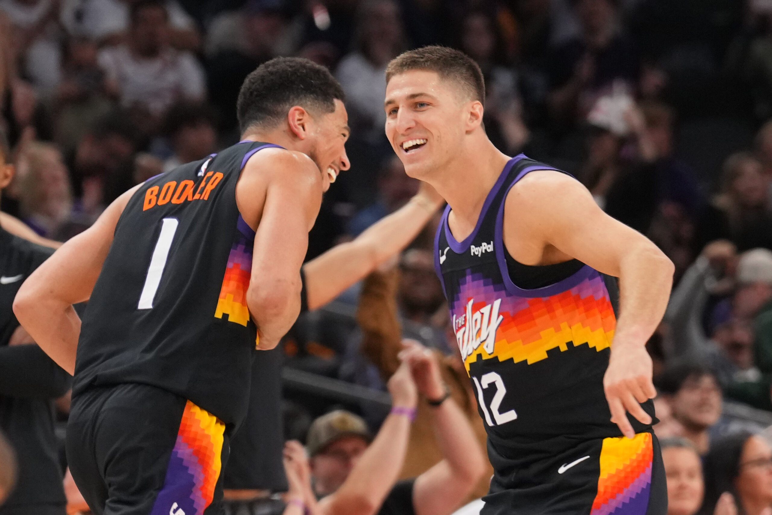 Mar 8, 2026; Phoenix, Arizona, USA; Phoenix Suns guard Devin Booker (1) and Phoenix Suns guard Collin Gillespie (12) react against the Charlotte Hornets during the second half at Mortgage Matchup Center. Mandatory Credit: Joe Camporeale-Imagn Images