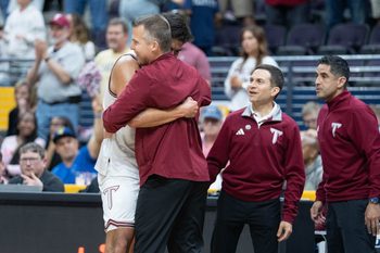 Trojans Victor Valdes (11) and head coach Scott Cross embrace as time runs down in their 77-61 victory over the Eagles during the Georgia Southern vs Troy men’s Sun Belt Conference Championship basketball game at the Pensacola Bay Center in Pensacola, Florida on March 9, 2026.