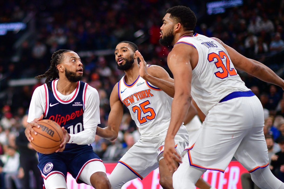 Mar 9, 2026; Inglewood, California, USA; Los Angeles Clippers guard Darius Garland (10) moves to the basket against New York Knicks guard Mikal Bridges (25) and center Karl-Anthony Towns (32) during the second half at Intuit Dome. Mandatory Credit: Gary A. Vasquez-Imagn Images