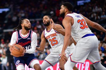 Mar 9, 2026; Inglewood, California, USA; Los Angeles Clippers guard Darius Garland (10) moves to the basket against New York Knicks guard Mikal Bridges (25) and center Karl-Anthony Towns (32) during the second half at Intuit Dome. Mandatory Credit: Gary A. Vasquez-Imagn Images