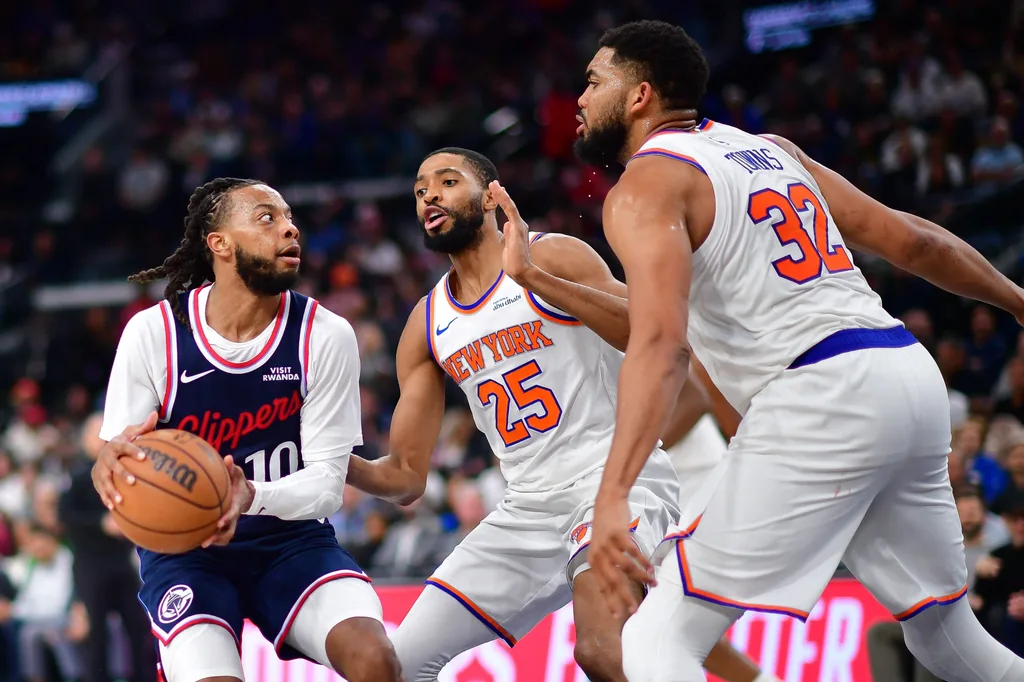Mar 9, 2026; Inglewood, California, USA; Los Angeles Clippers guard Darius Garland (10) moves to the basket against New York Knicks guard Mikal Bridges (25) and center Karl-Anthony Towns (32) during the second half at Intuit Dome. Mandatory Credit: Gary A. Vasquez-Imagn Images