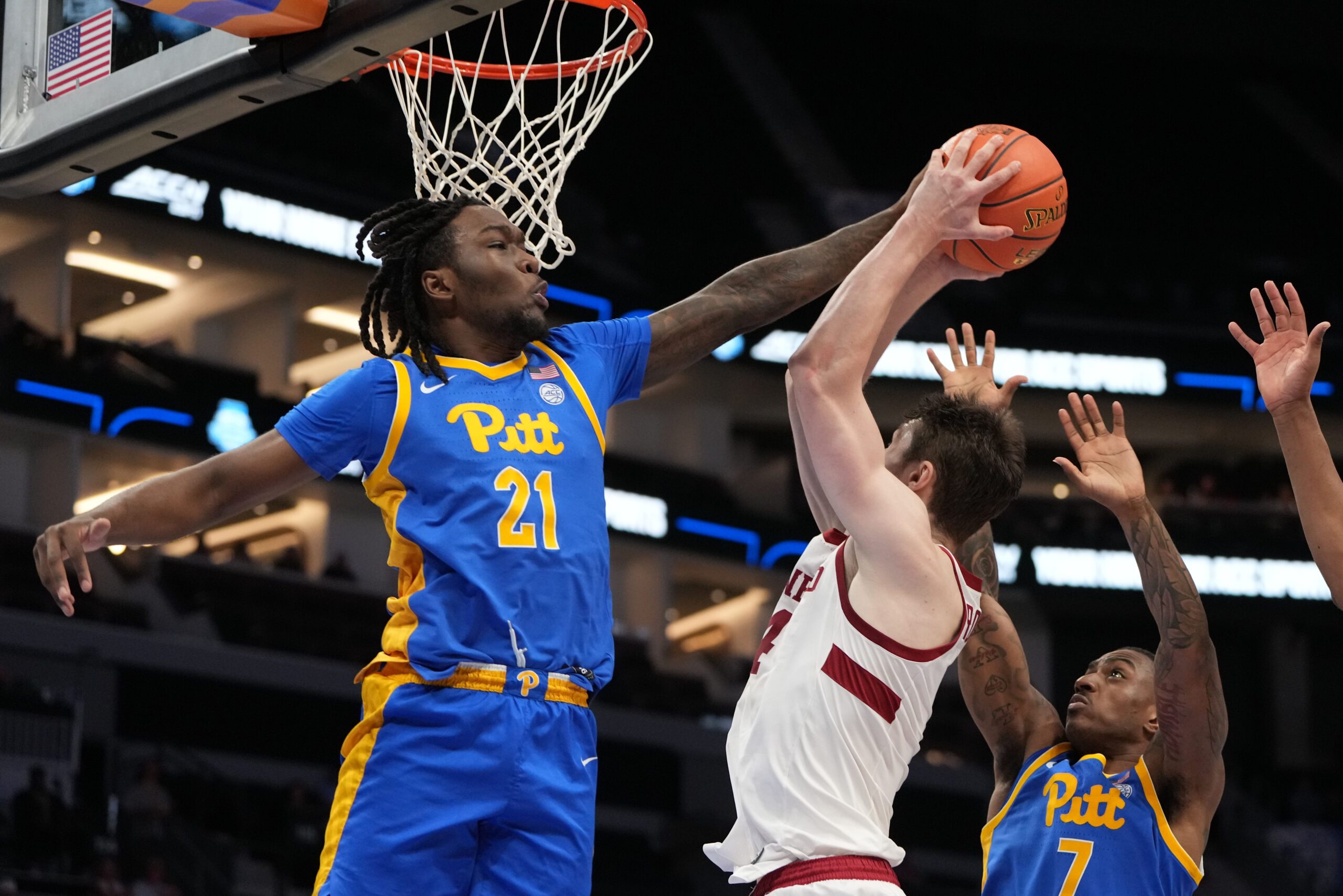 Mar 10, 2026; Charlotte, NC, USA; Pittsburgh Panthers guard MacAri Moore (21) blocks the shot of Stanford Cardinal forward AJ Rohosy (4) in the second half at Spectrum Center. Mandatory Credit: Bob Donnan-Imagn Images