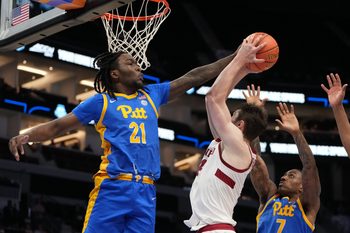 Mar 10, 2026; Charlotte, NC, USA; Pittsburgh Panthers guard MacAri Moore (21) blocks the shot of Stanford Cardinal forward AJ Rohosy (4) in the second half at Spectrum Center. Mandatory Credit: Bob Donnan-Imagn Images