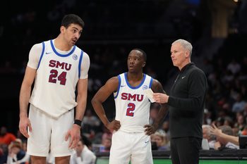Mar 10, 2026; Charlotte, NC, USA; Southern Methodist University Mustangs center Samet Yigitoglu (24) and guard Boopie Miller (2) with head coach Andy Enfield in the second half at Spectrum Center. Mandatory Credit: Bob Donnan-Imagn Images