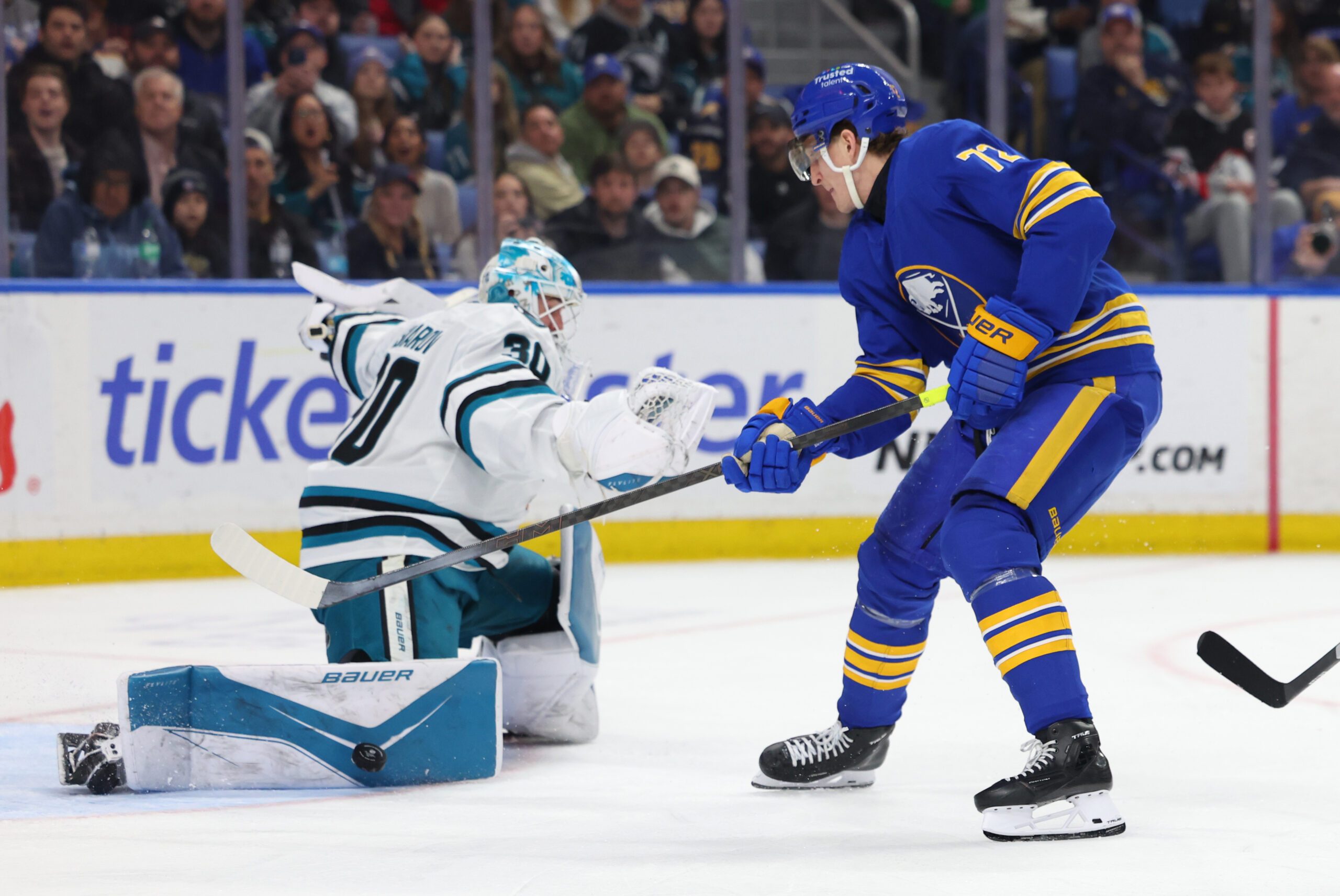 Mar 10, 2026; Buffalo, New York, USA;  San Jose Sharks goaltender Yaroslav Askarov (30) makes a pad save on Buffalo Sabres center Tage Thompson (72) during the second period at KeyBank Center. Mandatory Credit: Timothy T. Ludwig-Imagn Images