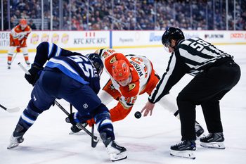 Mar 10, 2026; Winnipeg, Manitoba, CAN;  Winnipeg Jets forward Mark Scheifele (55) faces off against Anaheim Ducks forward Tim Washe (42) during the third period at Canada Life Centre. Mandatory Credit: Terrence Lee-Imagn Images