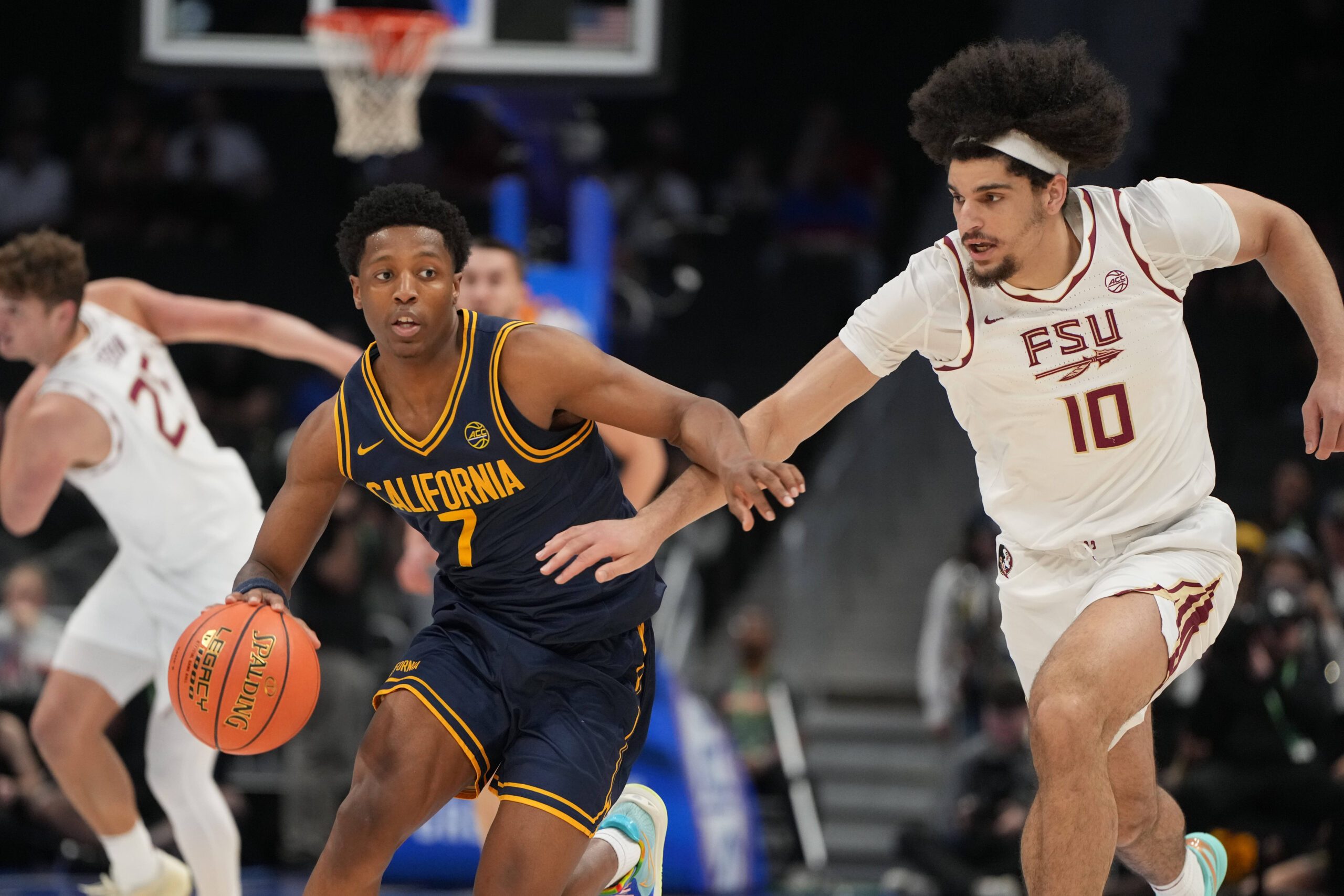 Mar 11, 2026; Charlotte, NC, USA; California Golden Bears guard Dai Dai Ames (7) with the ball as Florida State Seminoles guard Lajae Jones (10) defends in the first half at Spectrum Center. Mandatory Credit: Bob Donnan-Imagn Images