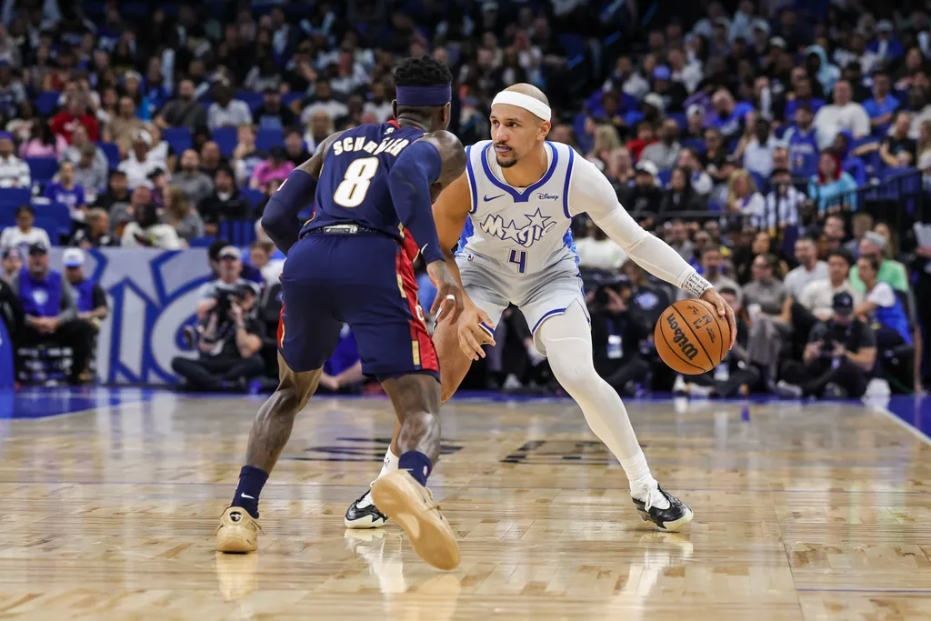 Mar 11, 2026; Orlando, Florida, USA; Orlando Magic guard Jalen Suggs (4) handles the ball in front of Cleveland Cavaliers guard Dennis Schroder (8) during the second quarter at Kia Center. Mandatory Credit: Mike Watters-Imagn Images