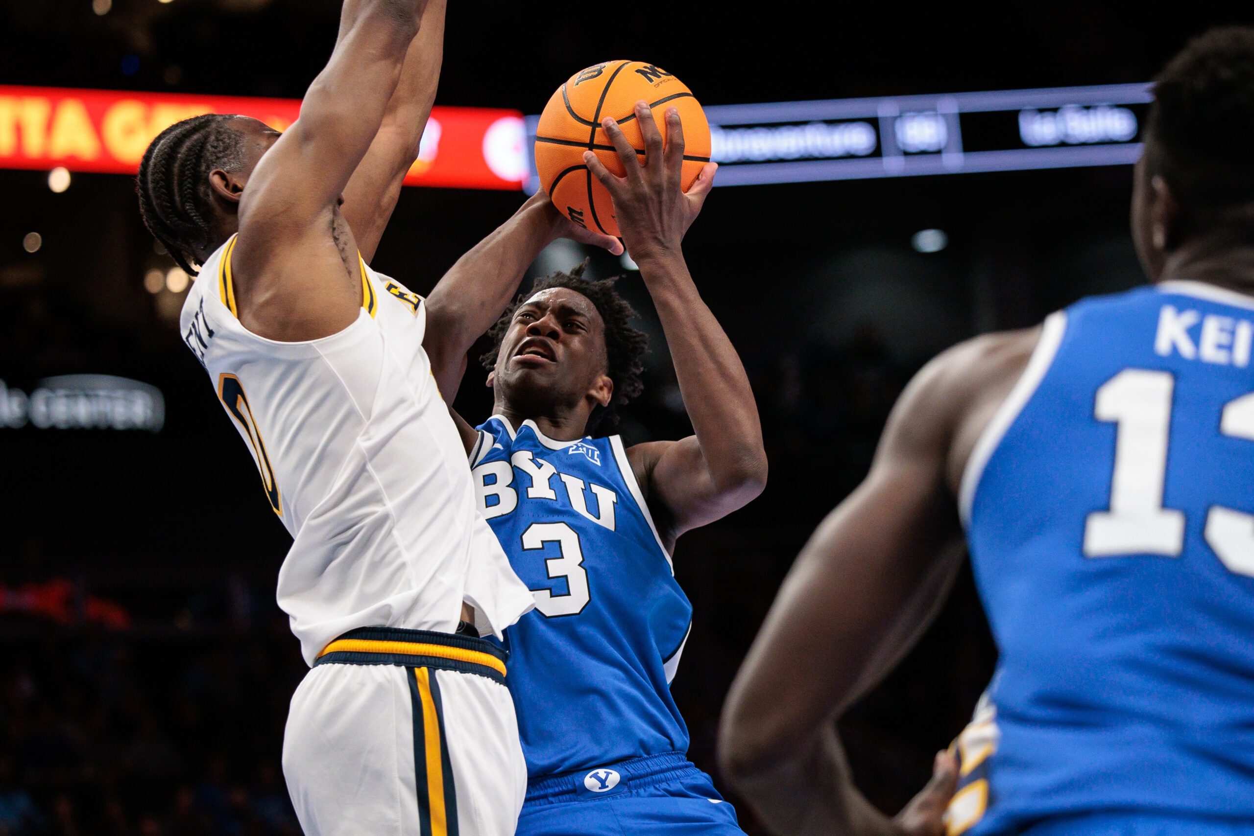 Mar 11, 2026; Kansas City, MO, USA; BYU Cougars forward AJ Dybantsa (3) collides with West Virginia Mountaineers forward Brenen Lorient (0) under the basket during the second half at T-Mobile Center. Mandatory Credit: William Purnell-Imagn Images
