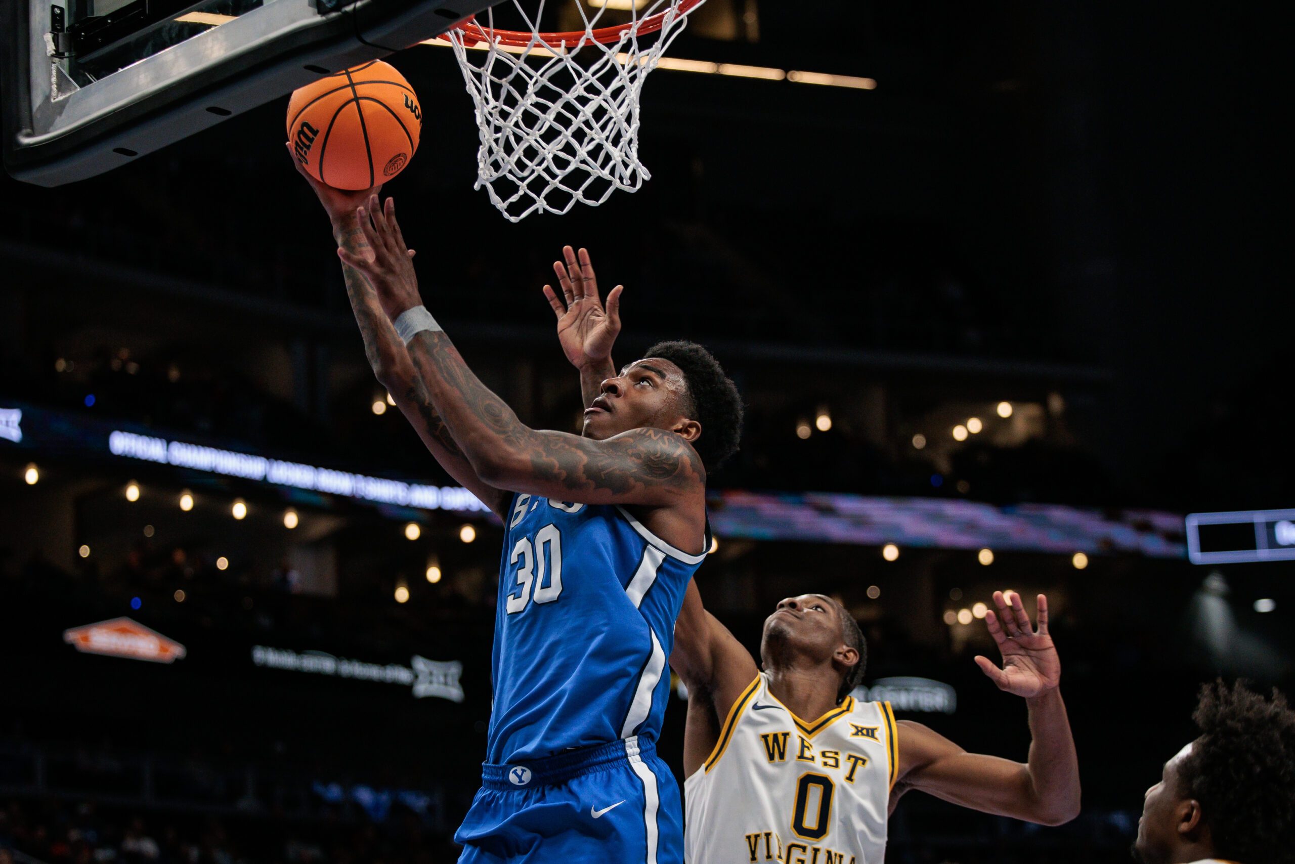 Mar 11, 2026; Kansas City, MO, USA; BYU Cougars forward Kennard Davis Jr. (30) shoots the ball over West Virginia Mountaineers forward Brenen Lorient (0) during the second half at T-Mobile Center. Mandatory Credit: William Purnell-Imagn Images
