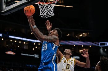 Mar 11, 2026; Kansas City, MO, USA; BYU Cougars forward Kennard Davis Jr. (30) shoots the ball over West Virginia Mountaineers forward Brenen Lorient (0) during the second half at T-Mobile Center. Mandatory Credit: William Purnell-Imagn Images