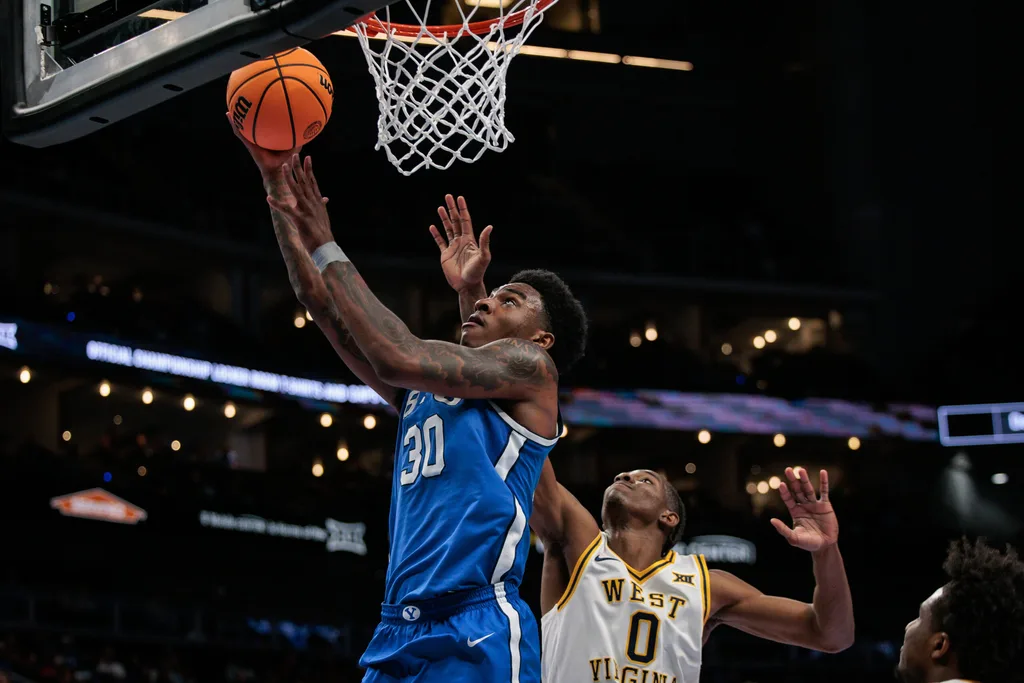 Mar 11, 2026; Kansas City, MO, USA; BYU Cougars forward Kennard Davis Jr. (30) shoots the ball over West Virginia Mountaineers forward Brenen Lorient (0) during the second half at T-Mobile Center. Mandatory Credit: William Purnell-Imagn Images