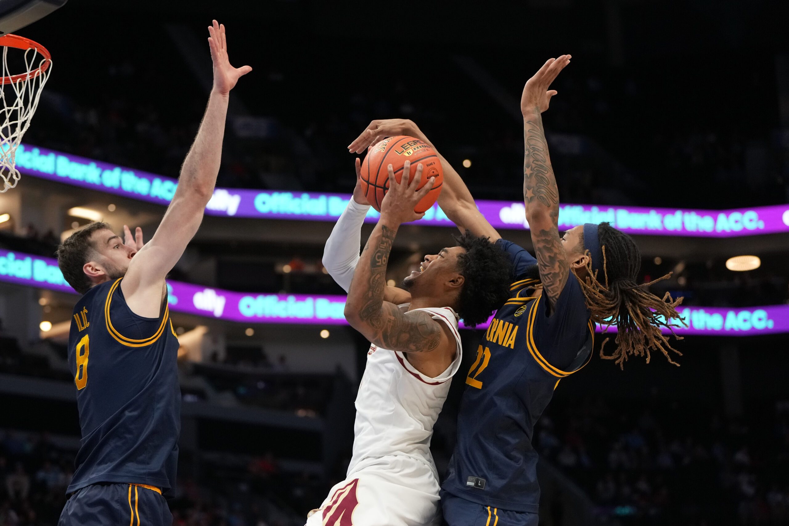 Mar 11, 2026; Charlotte, NC, USA; Florida State Seminoles guard Martin Somerville (1) shoots as California Golden Bears center Milos Ilic (8) and forward Chris Bell (22) defend in the second half at Spectrum Center. Mandatory Credit: Bob Donnan-Imagn Images