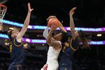 Mar 11, 2026; Charlotte, NC, USA; Florida State Seminoles guard Martin Somerville (1) shoots as California Golden Bears center Milos Ilic (8) and forward Chris Bell (22) defend in the second half at Spectrum Center. Mandatory Credit: Bob Donnan-Imagn Images