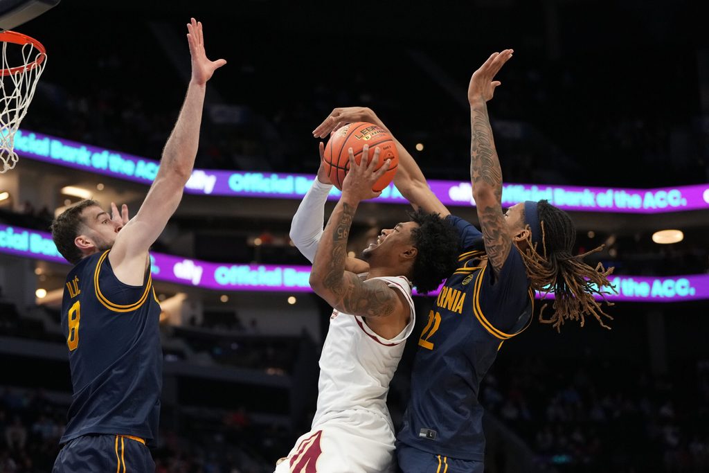 Mar 11, 2026; Charlotte, NC, USA; Florida State Seminoles guard Martin Somerville (1) shoots as California Golden Bears center Milos Ilic (8) and forward Chris Bell (22) defend in the second half at Spectrum Center. Mandatory Credit: Bob Donnan-Imagn Images