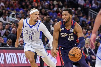Mar 11, 2026; Orlando, Florida, USA; Cleveland Cavaliers guard Donovan Mitchell (45) drives to the basket against Orlando Magic guard Jalen Suggs (4) during the second half at Kia Center. Mandatory Credit: Mike Watters-Imagn Images