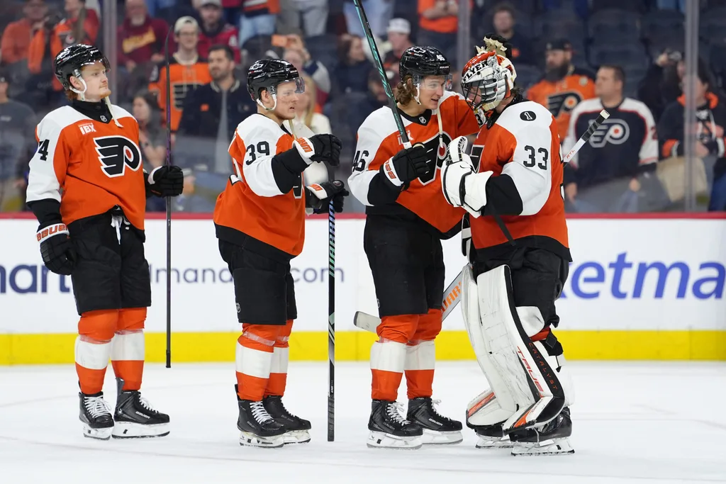 Mar 11, 2026; Philadelphia, Pennsylvania, USA; Philadelphia Flyers center Trevor Zegras (46) reacts with goalie Samuel Ersson (33) after the game against the Washington Capitals at Xfinity Mobile Arena. Mandatory Credit: Kyle Ross-Imagn Images