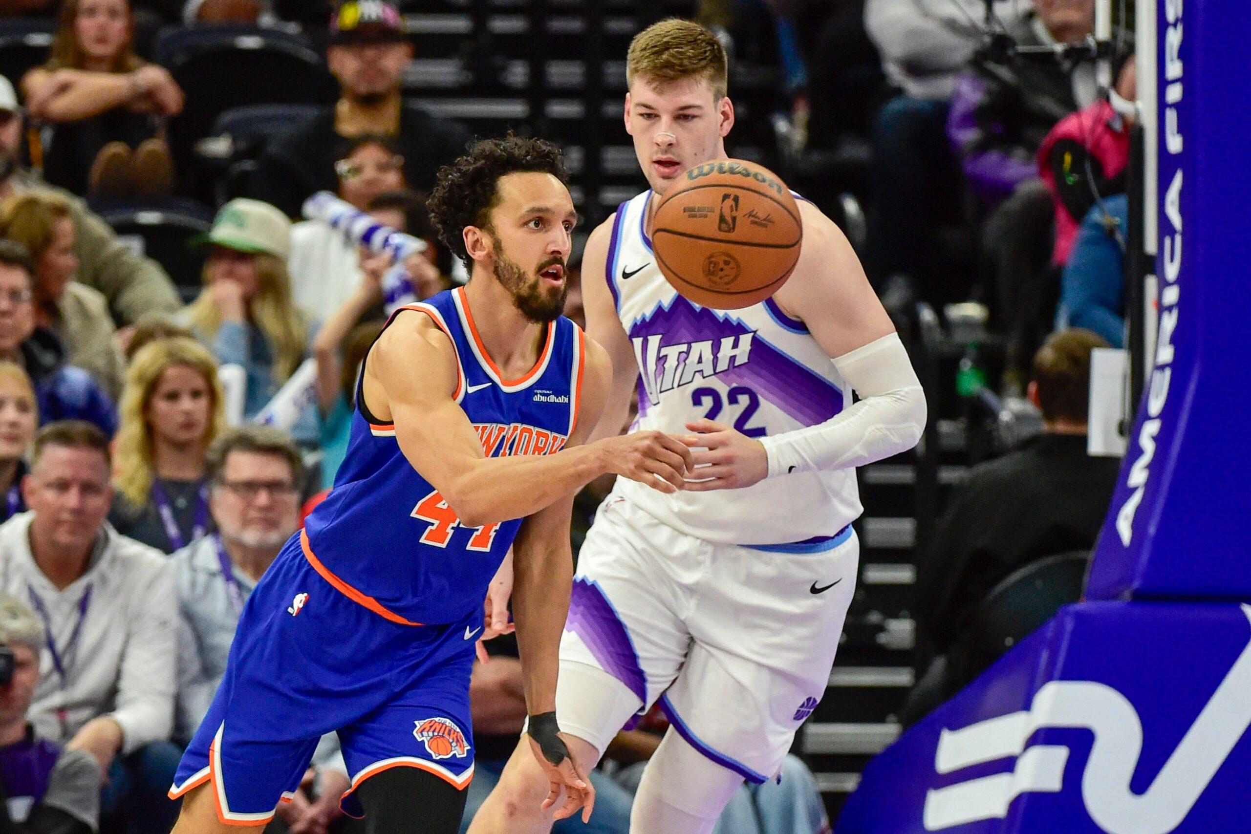 Mar 11, 2026; Salt Lake City, Utah, USA; New York Knicks guard Landry Shamet (44) makes a quick pass around Utah Jazz center Kyle Filipowski (22) during the second half at Delta Center. Mandatory Credit: Peter Creveling-Imagn Images