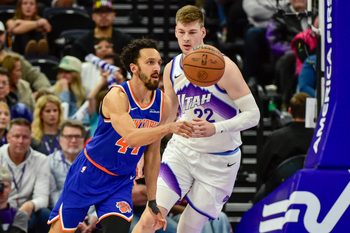 Mar 11, 2026; Salt Lake City, Utah, USA; New York Knicks guard Landry Shamet (44) makes a quick pass around Utah Jazz center Kyle Filipowski (22) during the second half at Delta Center. Mandatory Credit: Peter Creveling-Imagn Images