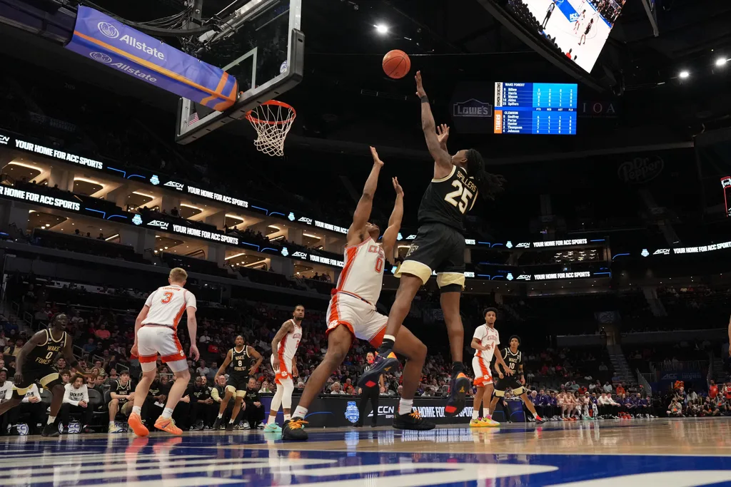Mar 11, 2026; Charlotte, NC, USA; Wake Forest Demon Deacons forward Tre'von Spillers (25) takes a jump shot over Clemson Tigers forward RJ Godfrey (0) during the second half at Spectrum Center. Mandatory Credit: Jim Dedmon-Imagn Images