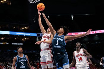Mar 12, 2026; Kansas City, MO, USA; Houston Cougars guard Kingston Flemings (4) shoots the ball around BYU Cougars guard Robert Wright III (1) during the first half at T-Mobile Center. Mandatory Credit: William Purnell-Imagn Images