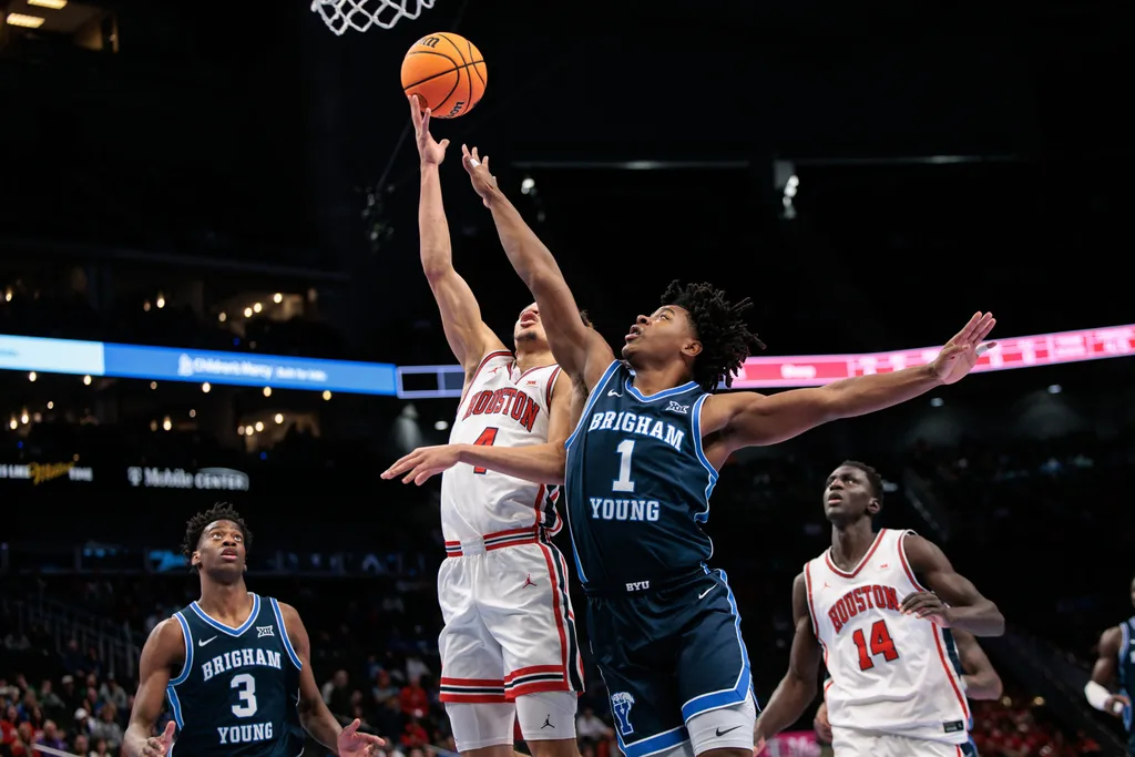 Mar 12, 2026; Kansas City, MO, USA; Houston Cougars guard Kingston Flemings (4) shoots the ball around BYU Cougars guard Robert Wright III (1) during the first half at T-Mobile Center. Mandatory Credit: William Purnell-Imagn Images