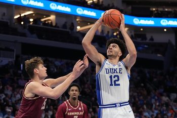 Mar 12, 2026; Charlotte, NC, USA; Duke Blue Devils forward Cameron Boozer (12) shoots as Florida State Seminoles forward Alex Steen (25) defends in the second half at Spectrum Center. Mandatory Credit: Bob Donnan-Imagn Images