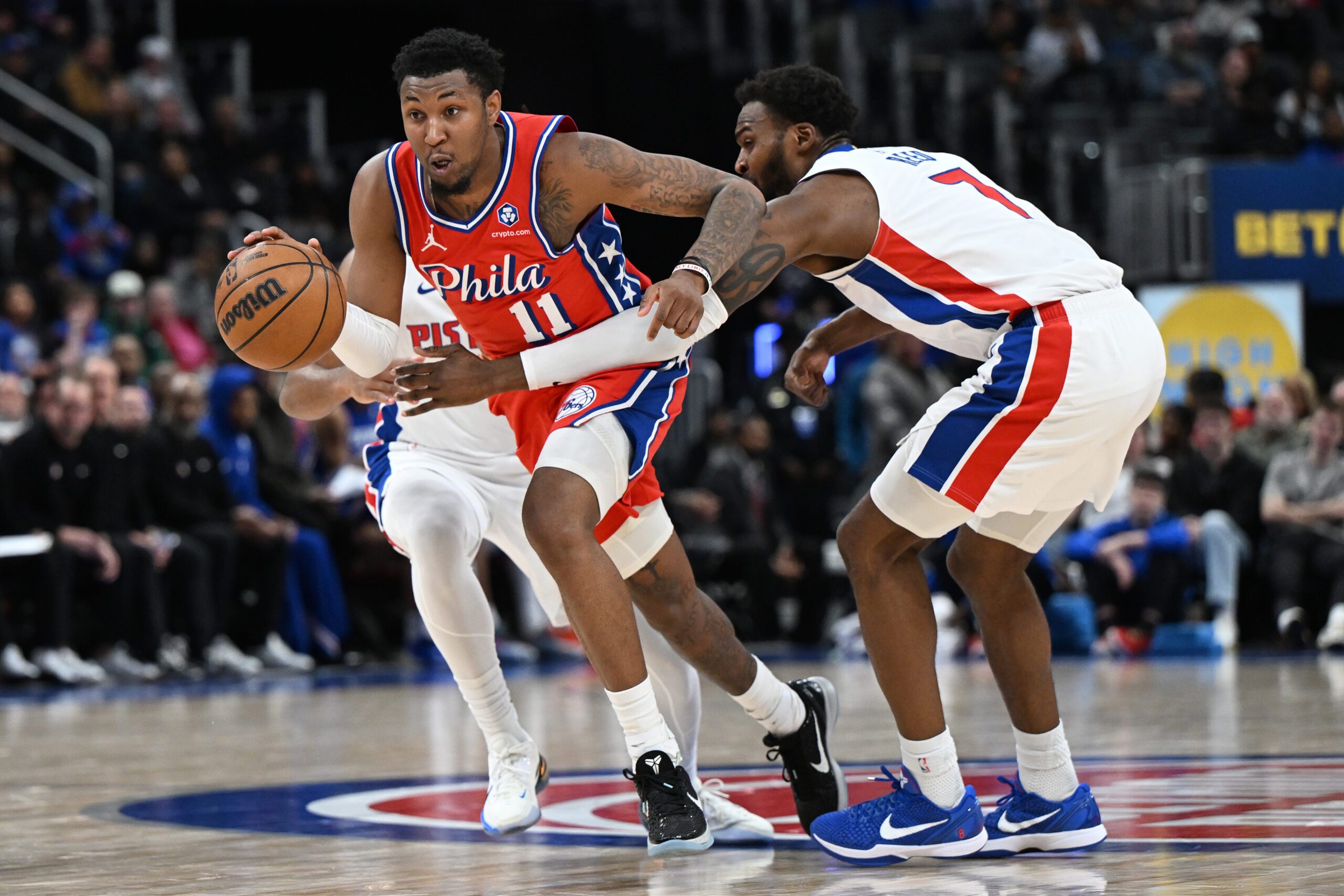 Mar 12, 2026; Detroit, Michigan, USA; Philadelphia 76ers forward Justin Edwards (11) drives past Detroit Pistons forward Paul Reed (7) in the second half at Little Caesars Arena. Mandatory Credit: Lon Horwedel-Imagn Images