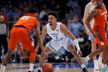 Mar 12, 2026; Charlotte, NC, USA; North Carolina Tar Heels guard Seth Trimble (7) on defense against Clemson Tigers guard Ace Buckner (21) during the first half at Spectrum Center. Mandatory Credit: Jim Dedmon-Imagn Images